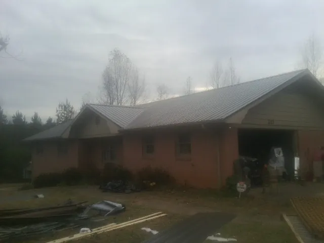 Gray metal roof on a stucco house with an attached garage in Lava Hot Springs