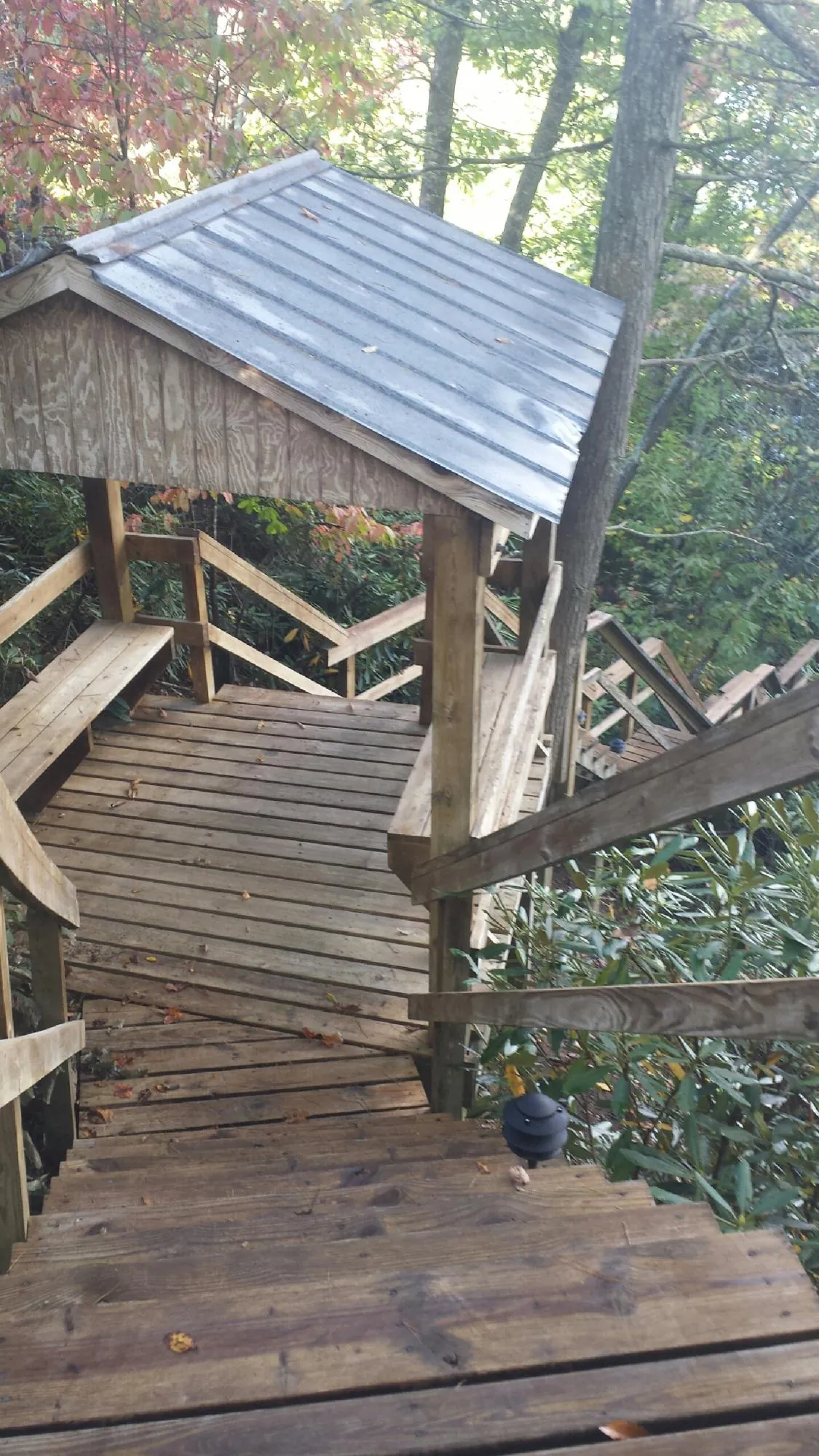 Metal roofed shelter over wooden steps on a wooded walkway — Skylight Repair & Installation work by our crew in Lava Hot Springs